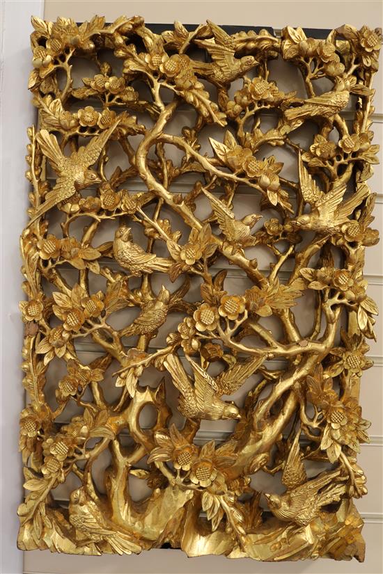 A set of six Chinese carved giltwood panels of birds amid prunus